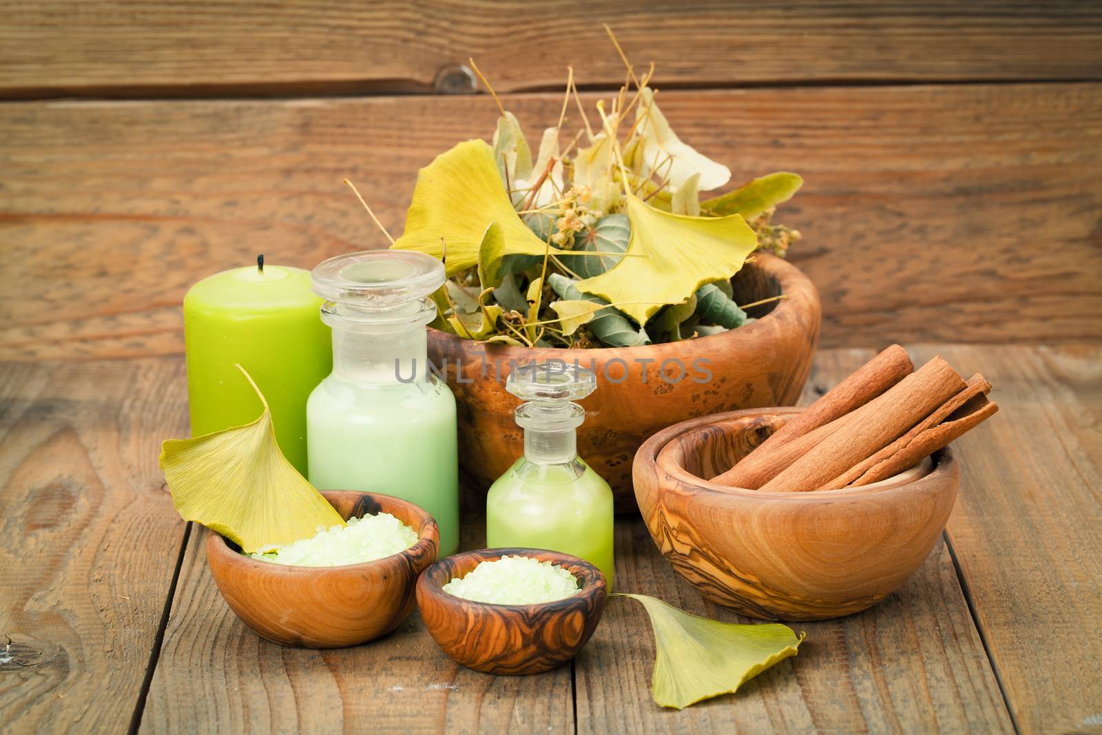 herbal salt in the wooden bowl and herb on wooden background.