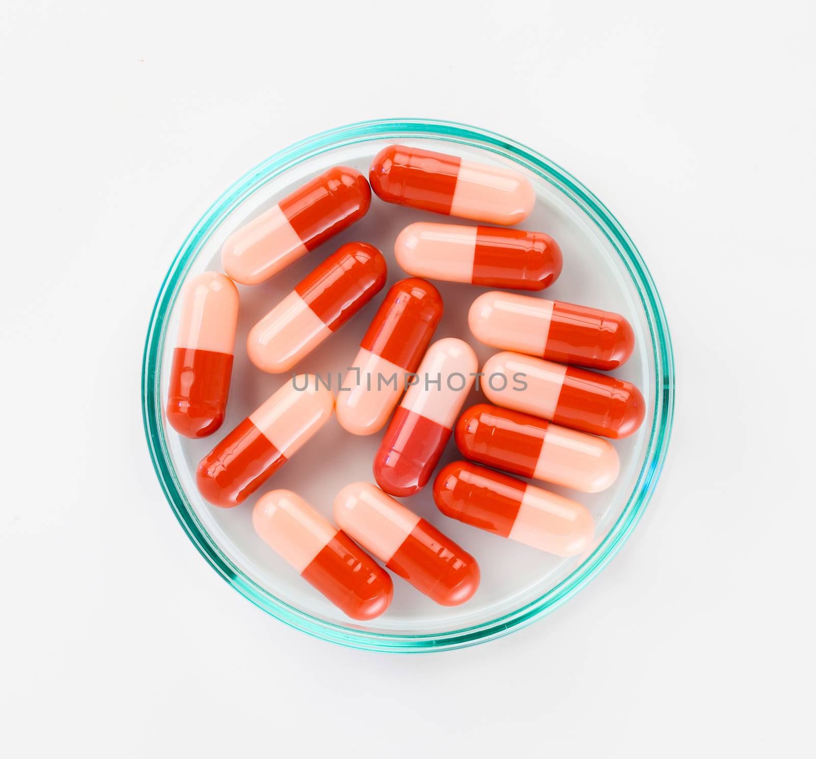 Close up of red medical capsules on white background