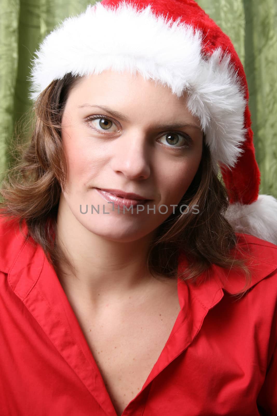 Beautiful Brunette model with a christmas hat and red top 