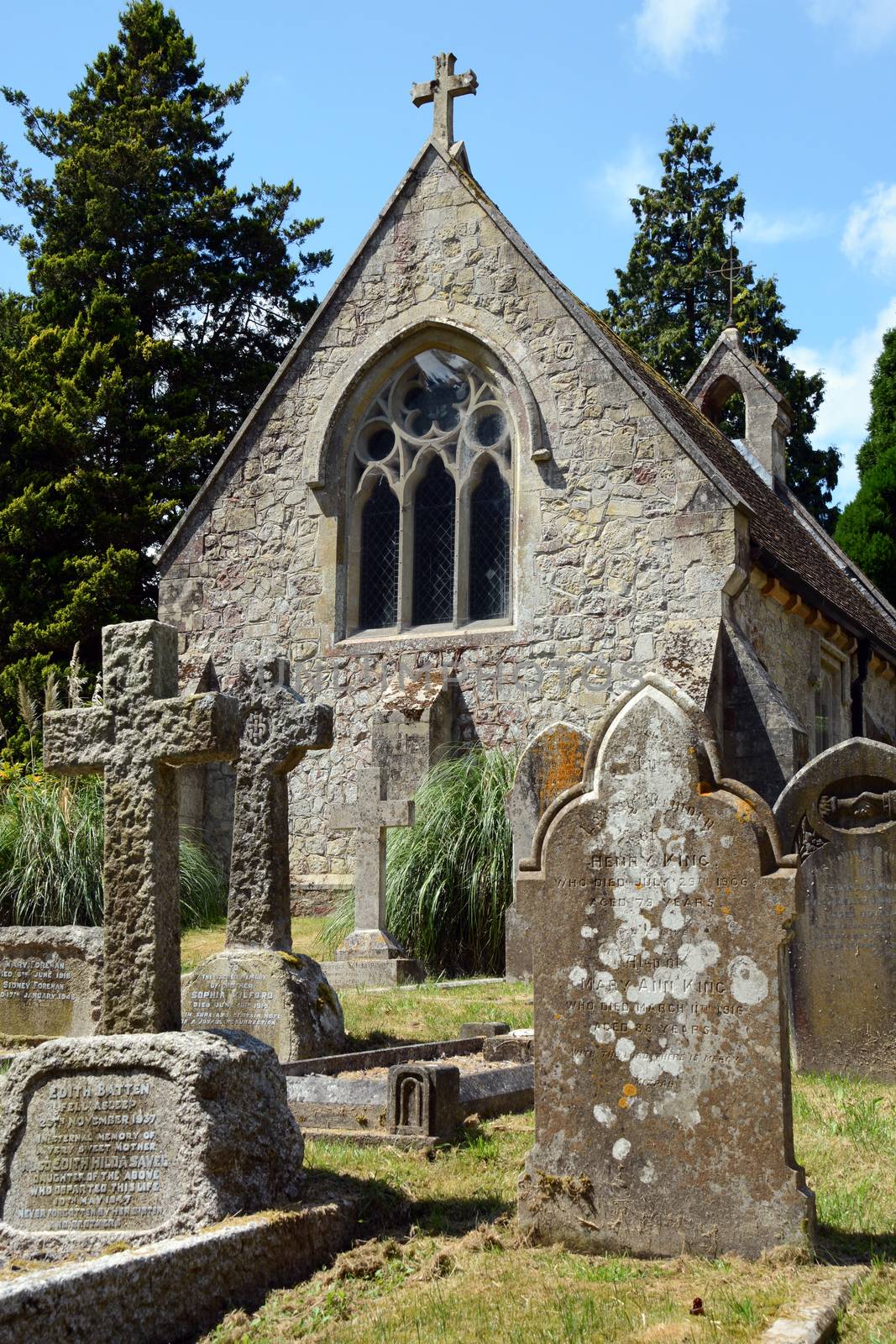 Lyndhurst, UK - July 13, 2014: Small stone chapel in the village of Lyndhurst in the New Forest, surrounded by a variety of weathered tombstones