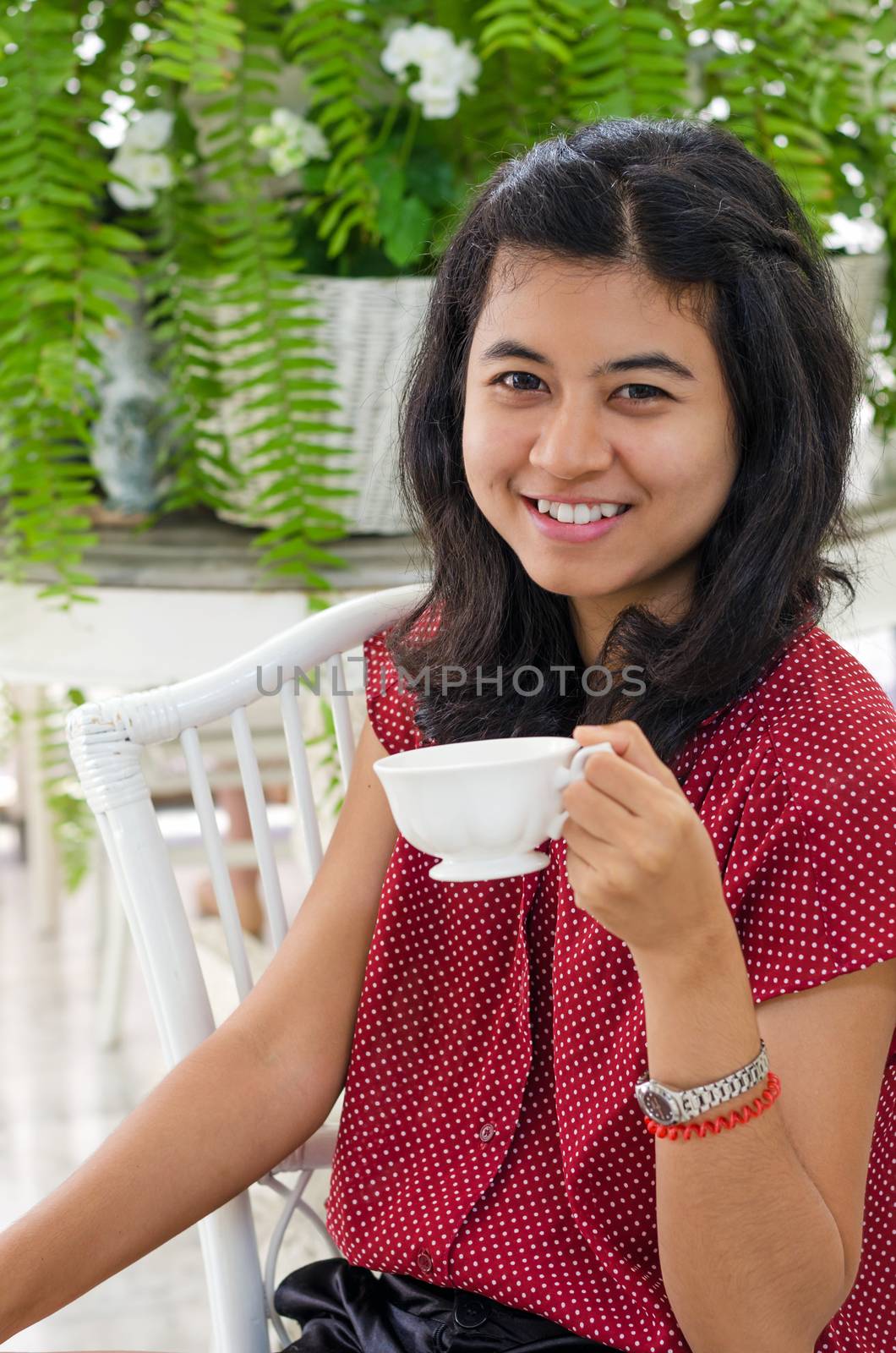 Woman at home with a tea from a cup  by siraanamwong