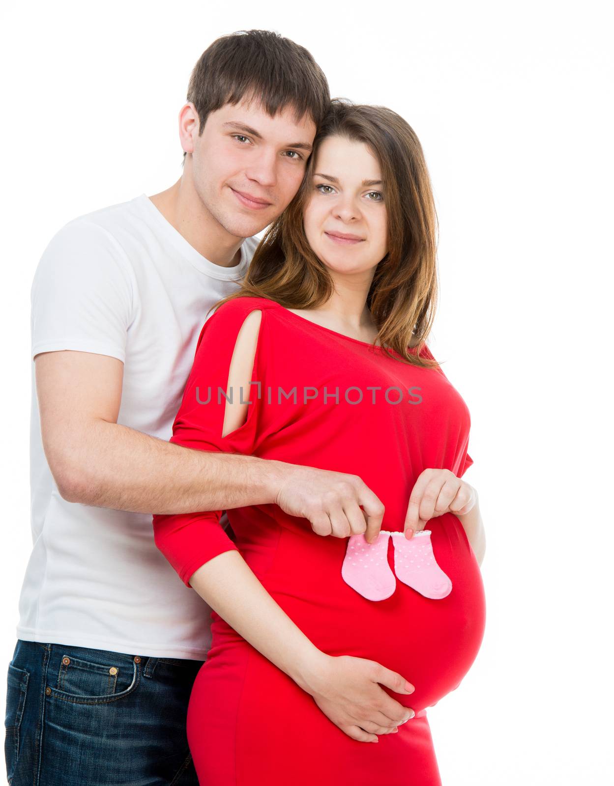 husband hugging pregnant wife with pink socks for baby isolated on a white background