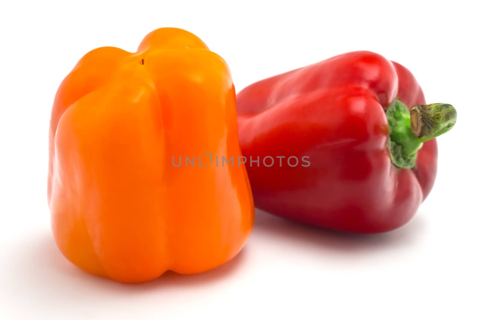 Two juicy peppers on a white background