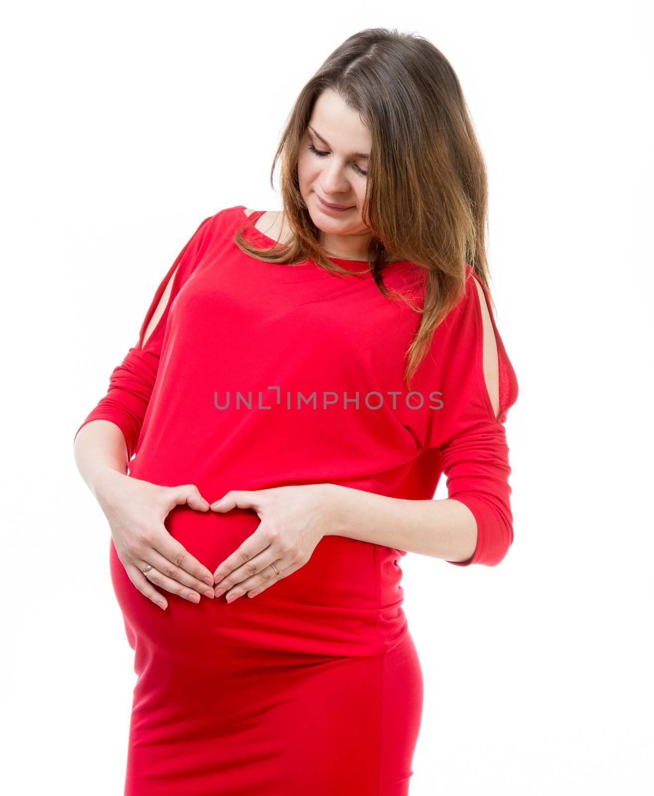 beautiful pregnant woman holding hands in heart shape