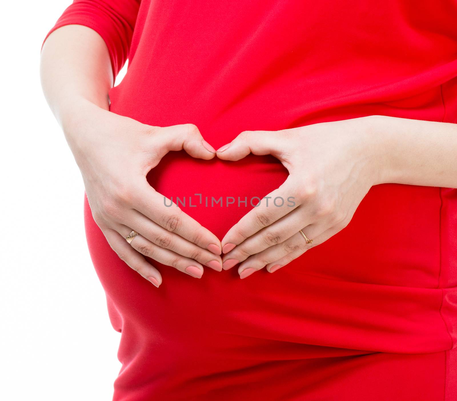 pregnant woman holding hands in heart shape