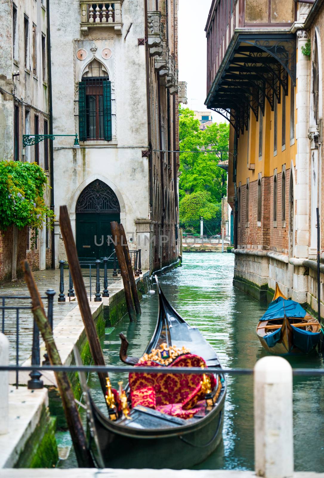 Venice cityscape, narrow water canal with gondolas