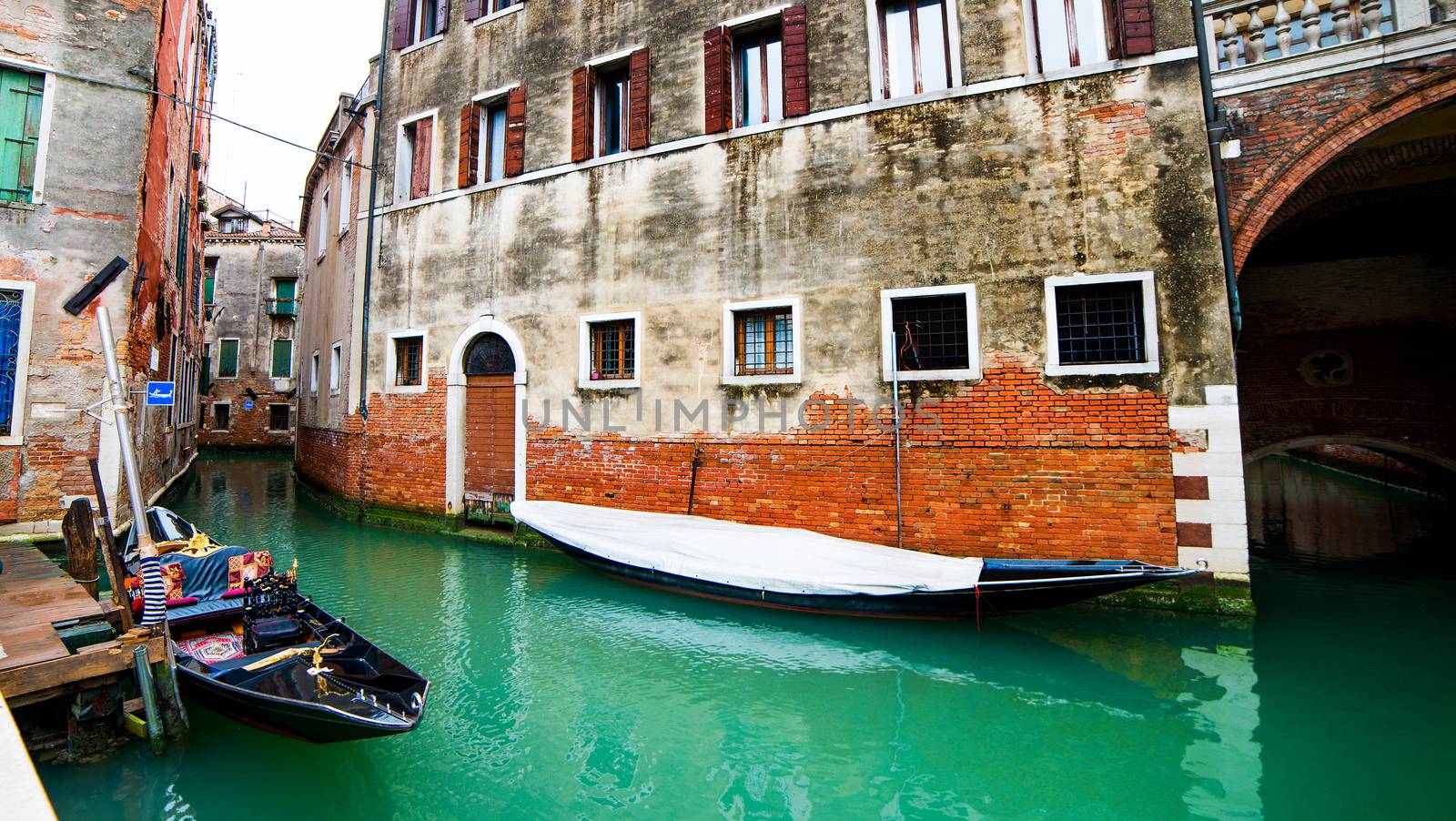 Gondola on Venice canal with houses on the street