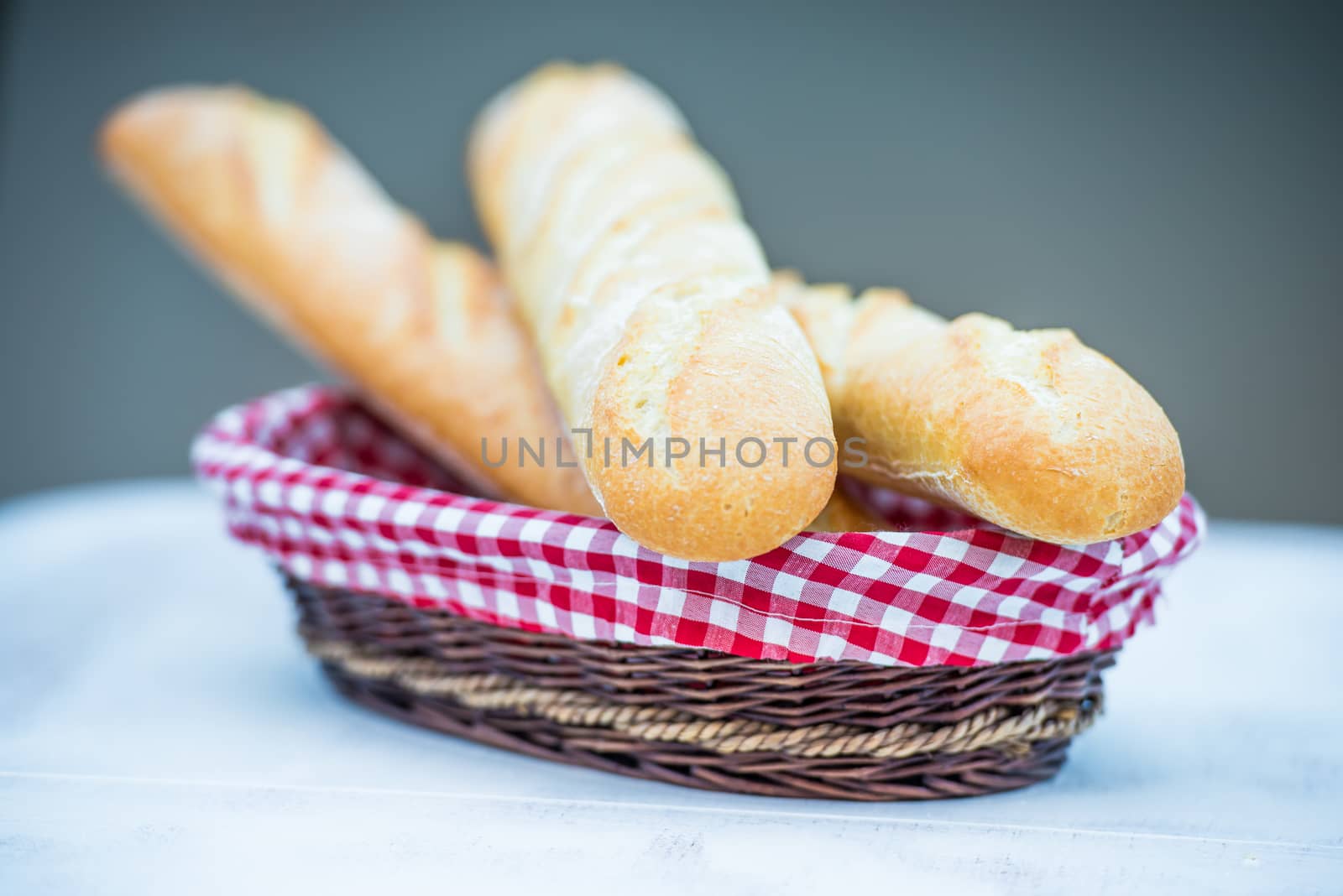 delicious fresh baguette in a basket on table