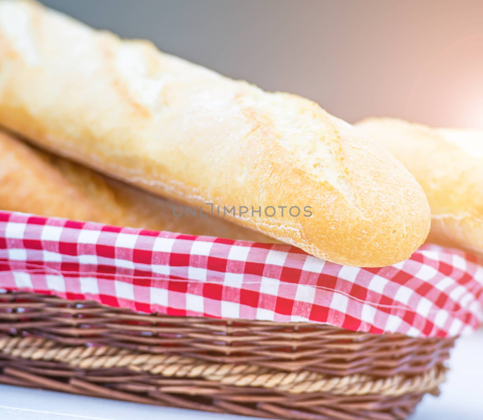 delicious fresh baguette in a basket on table