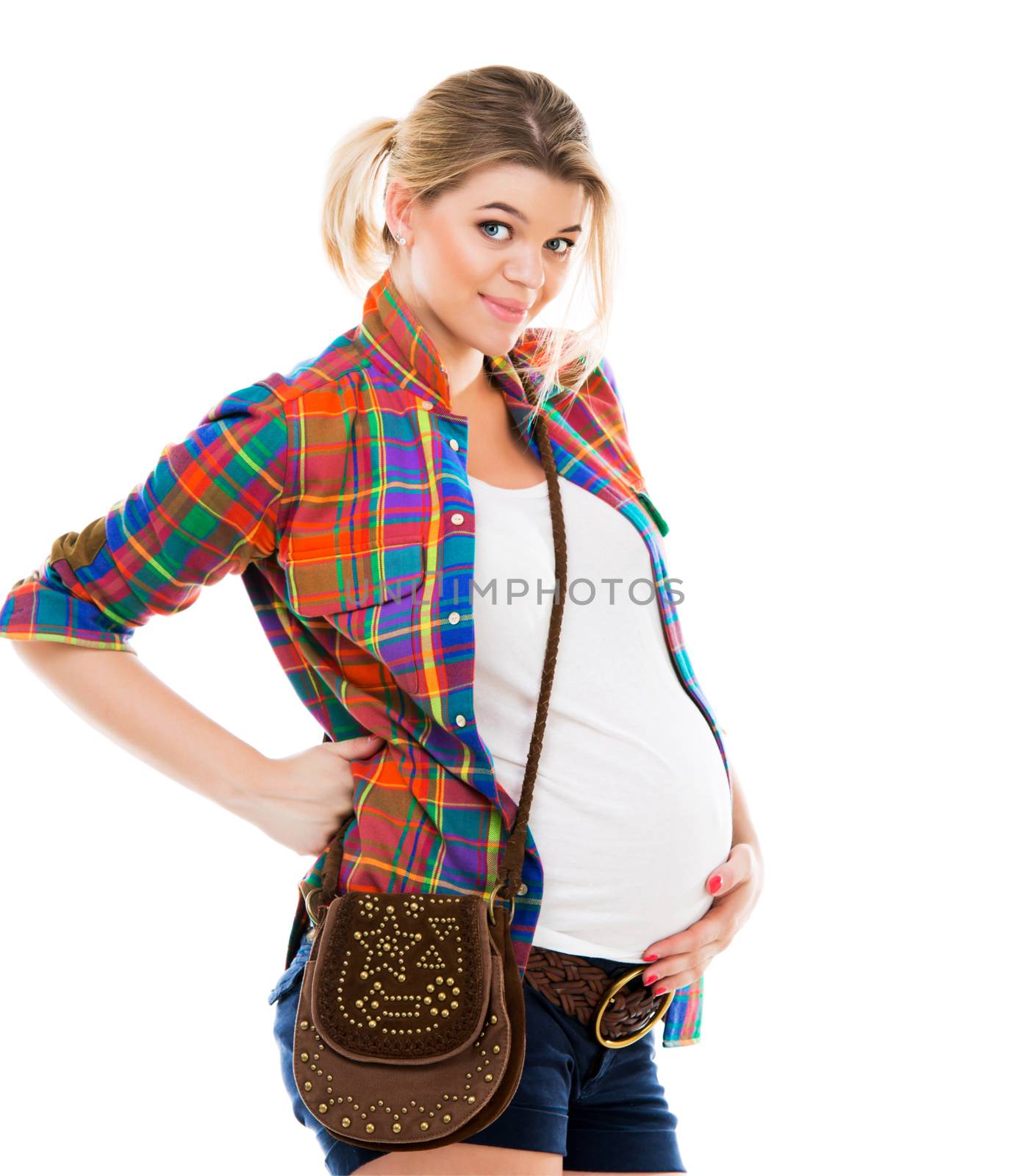 Beautiful pregnant white woman wearing shirt with hands on belly isolated on a white background