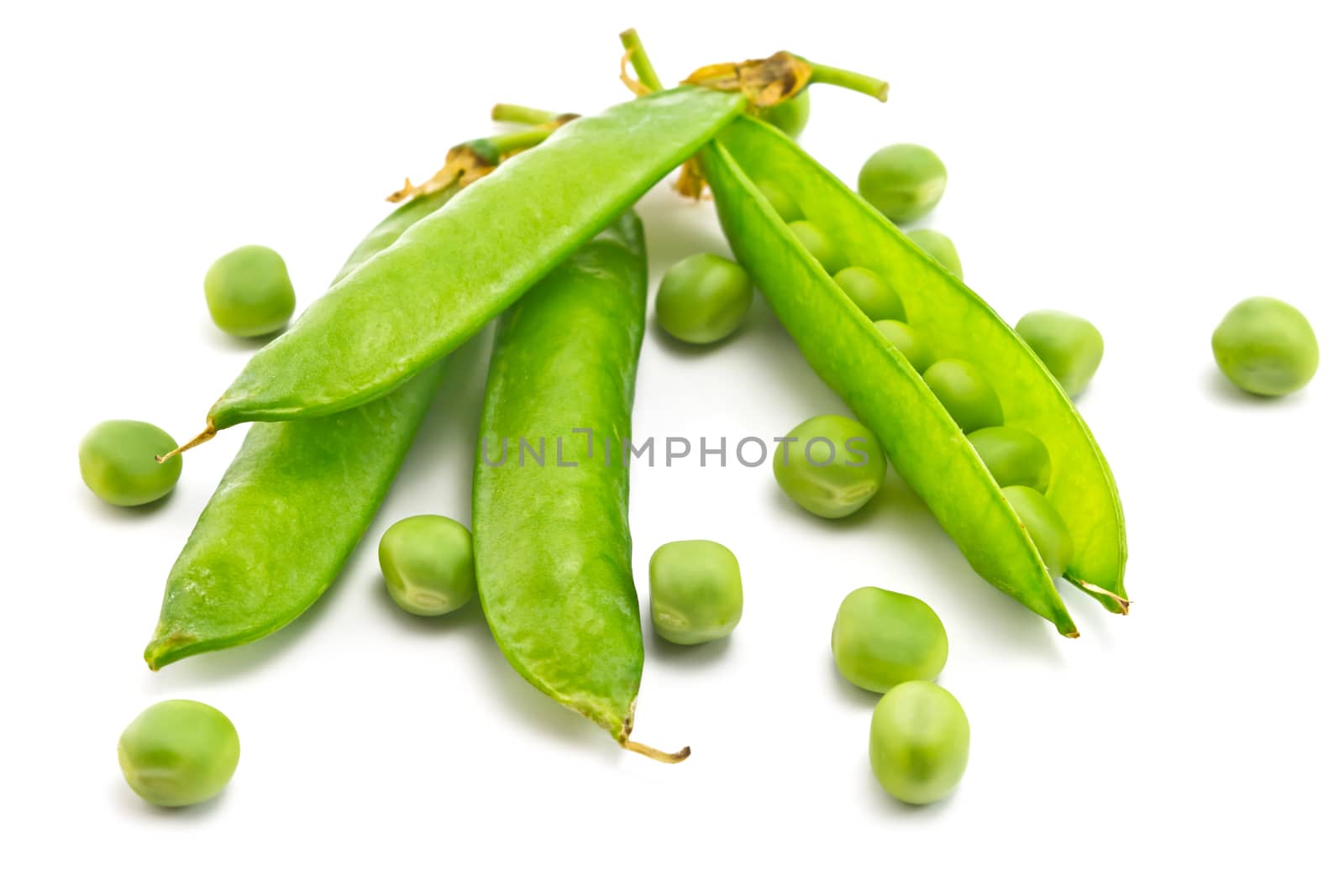 pods of green peas and some peas on a white background