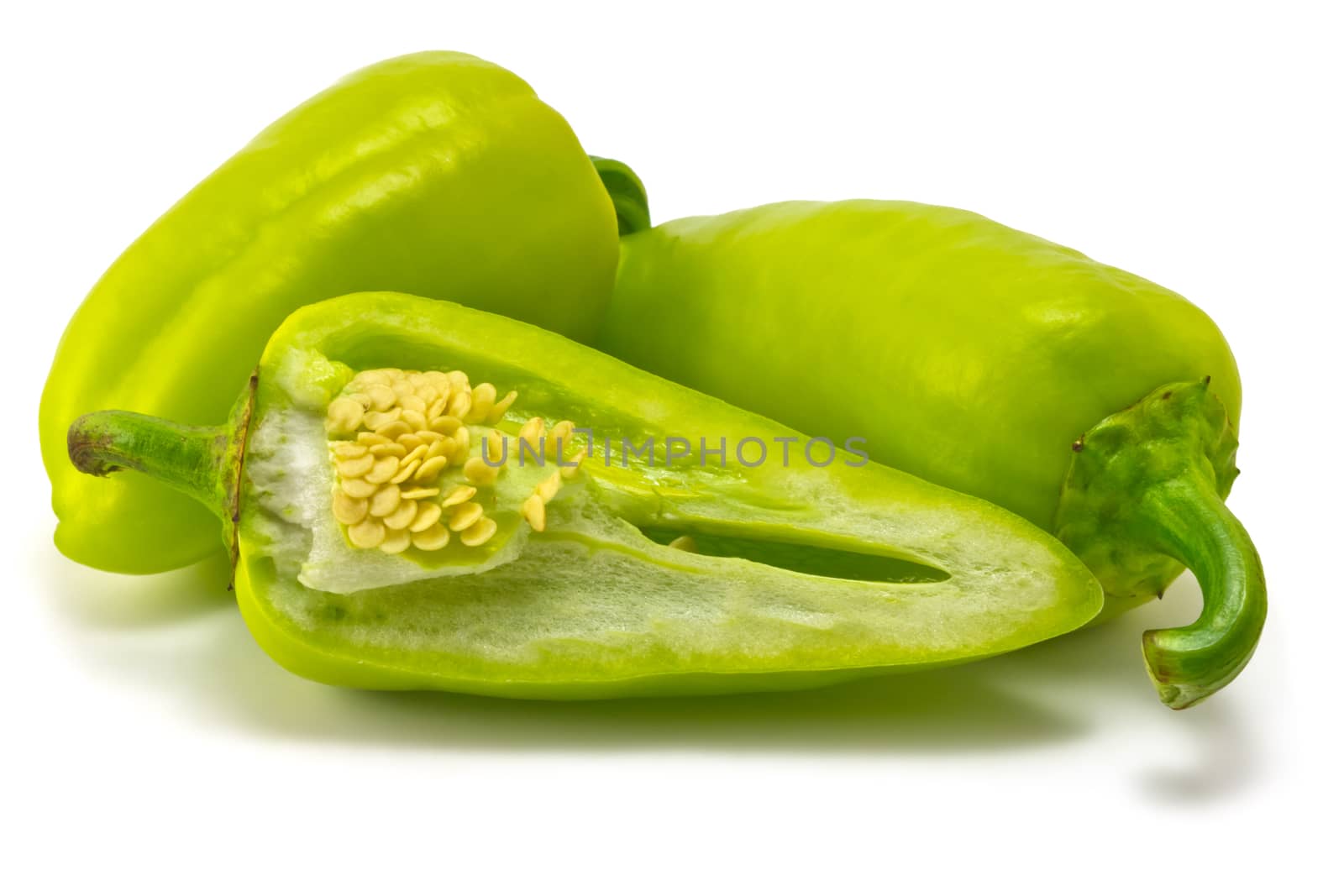 green sweet peppers on a white background