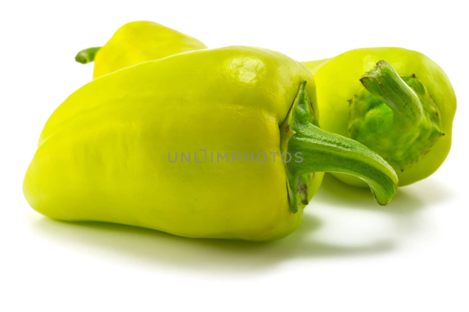 green sweet peppers on a white background