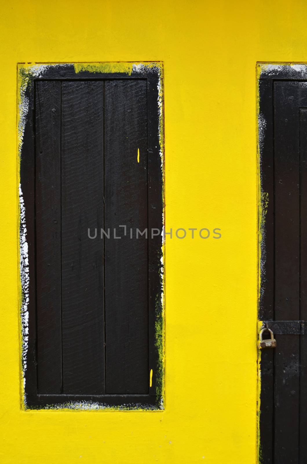 Wooden window with yellow wall