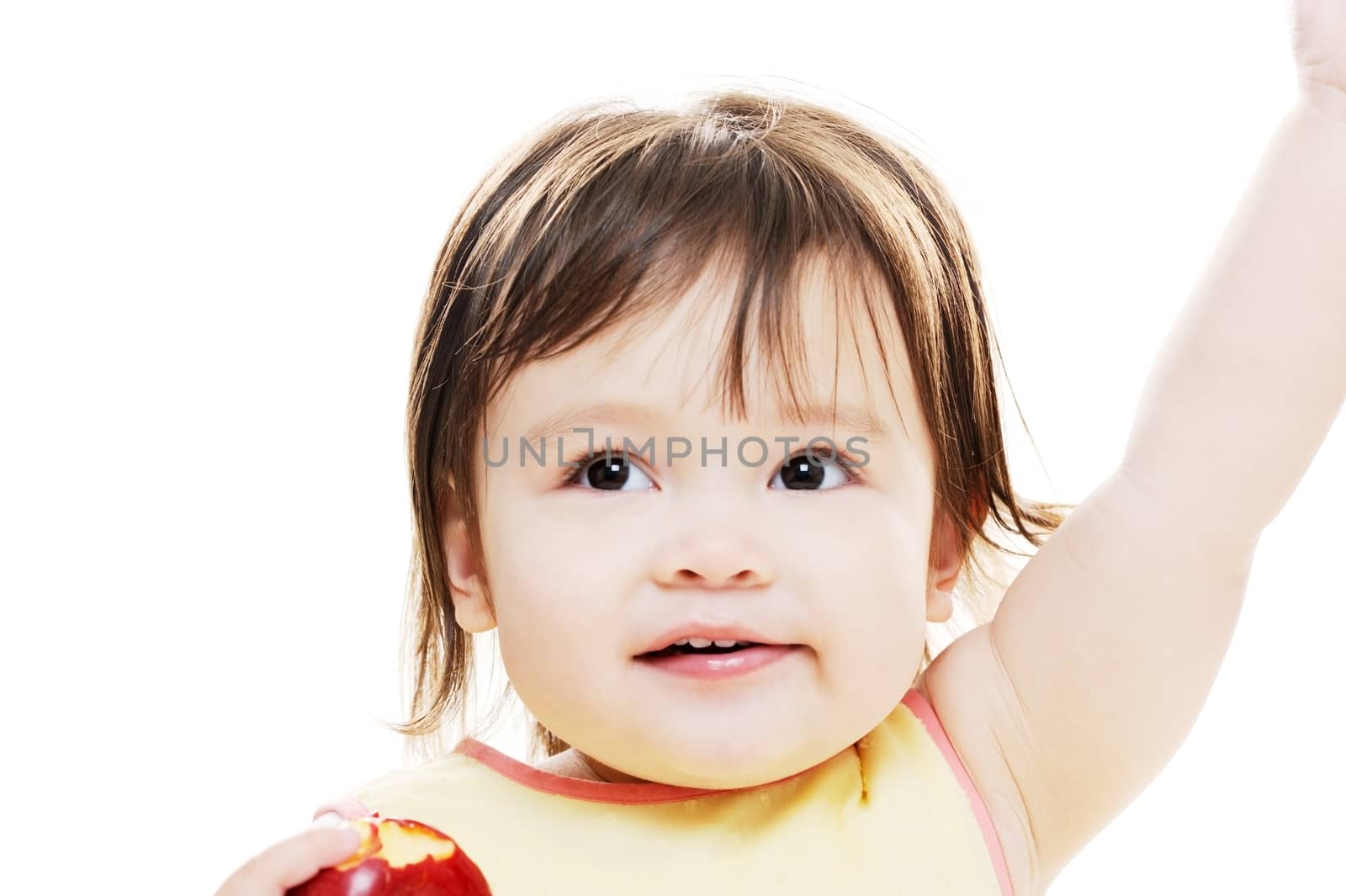 Young girl looking happy holding apple