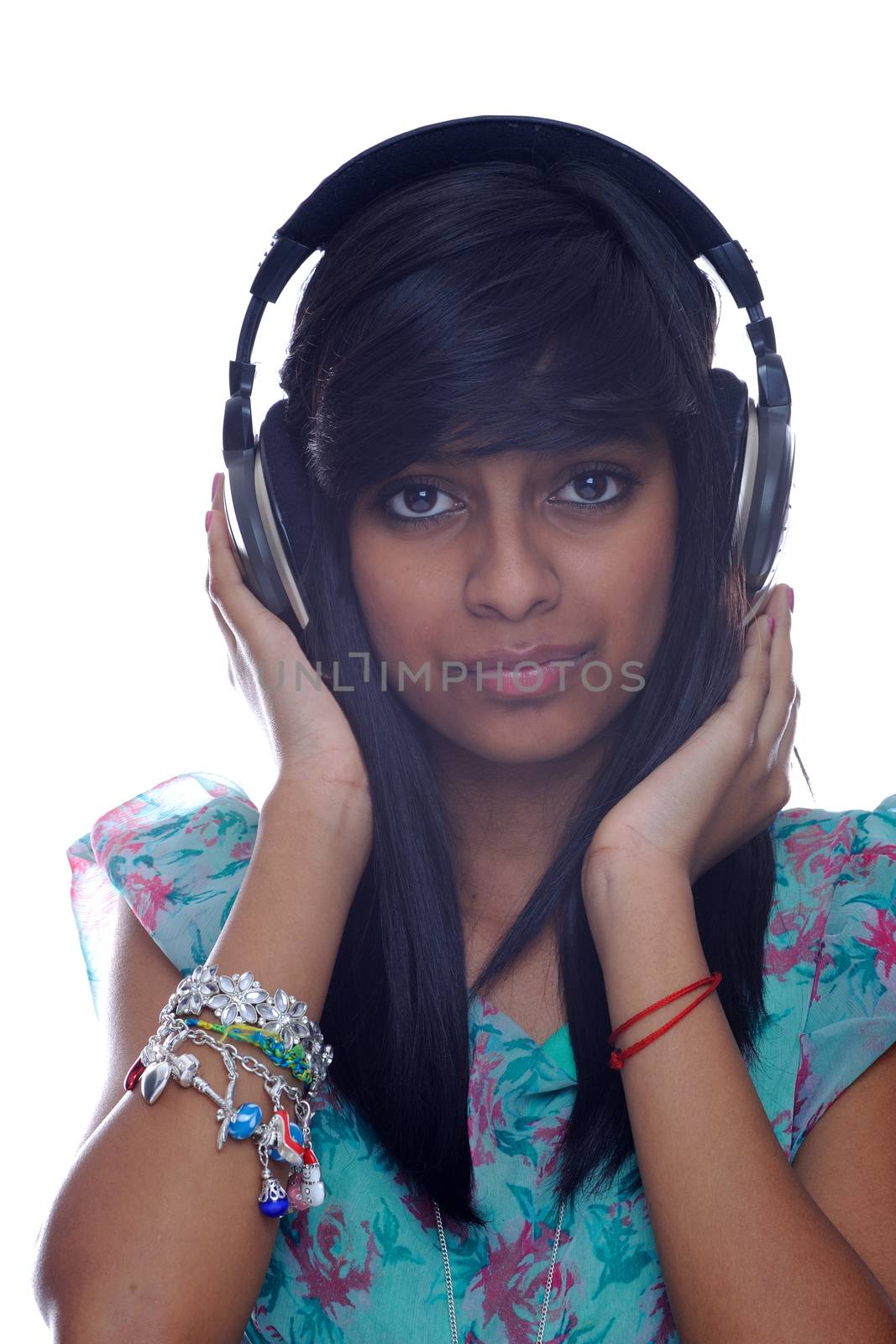 Teen girl from india holding headphones