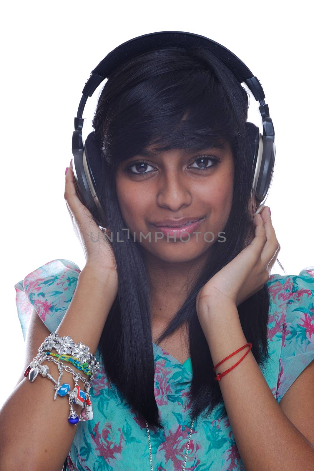 Teenager from India wears headphones