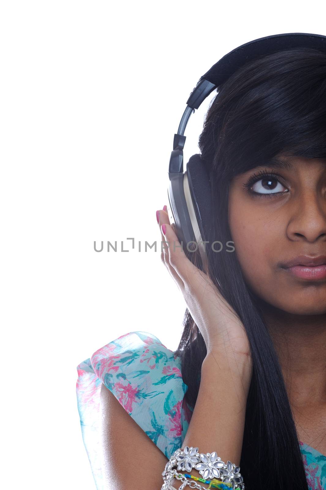 Teen girl listens to music with headphones