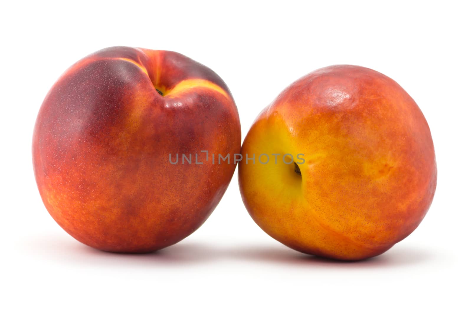 two juicy ripe nectarine on a white background