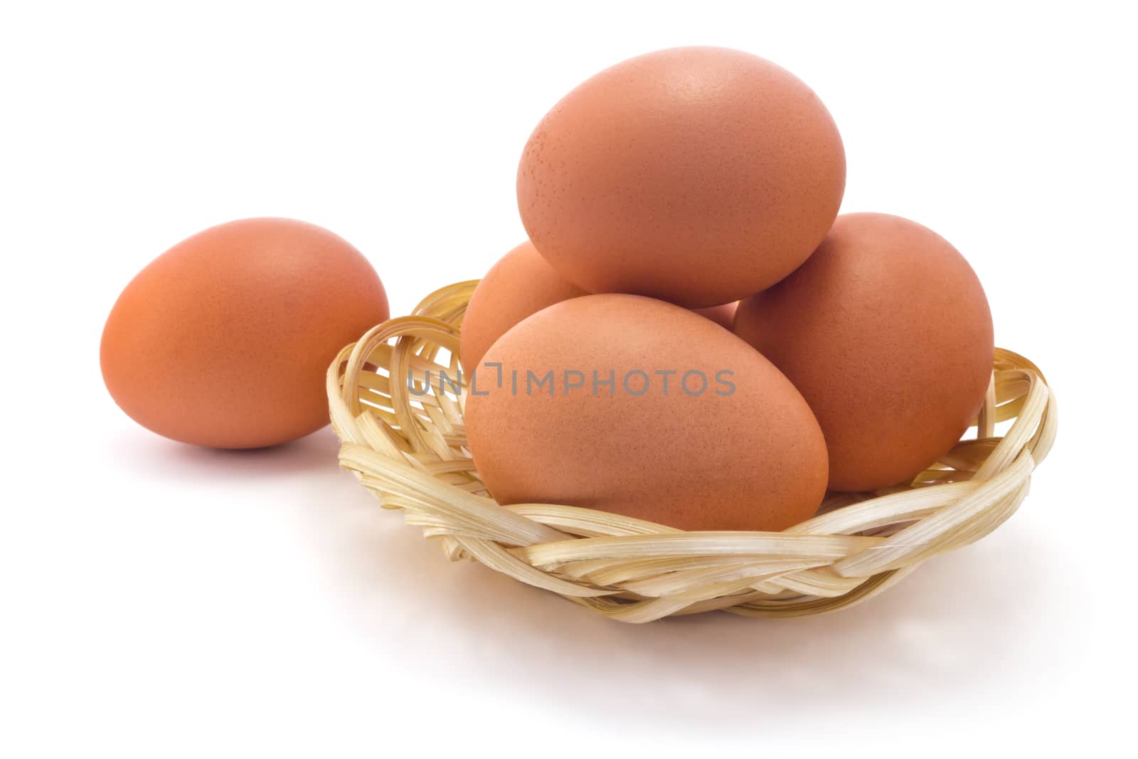 boiled eggs in a straw wall outlet isolated on white background