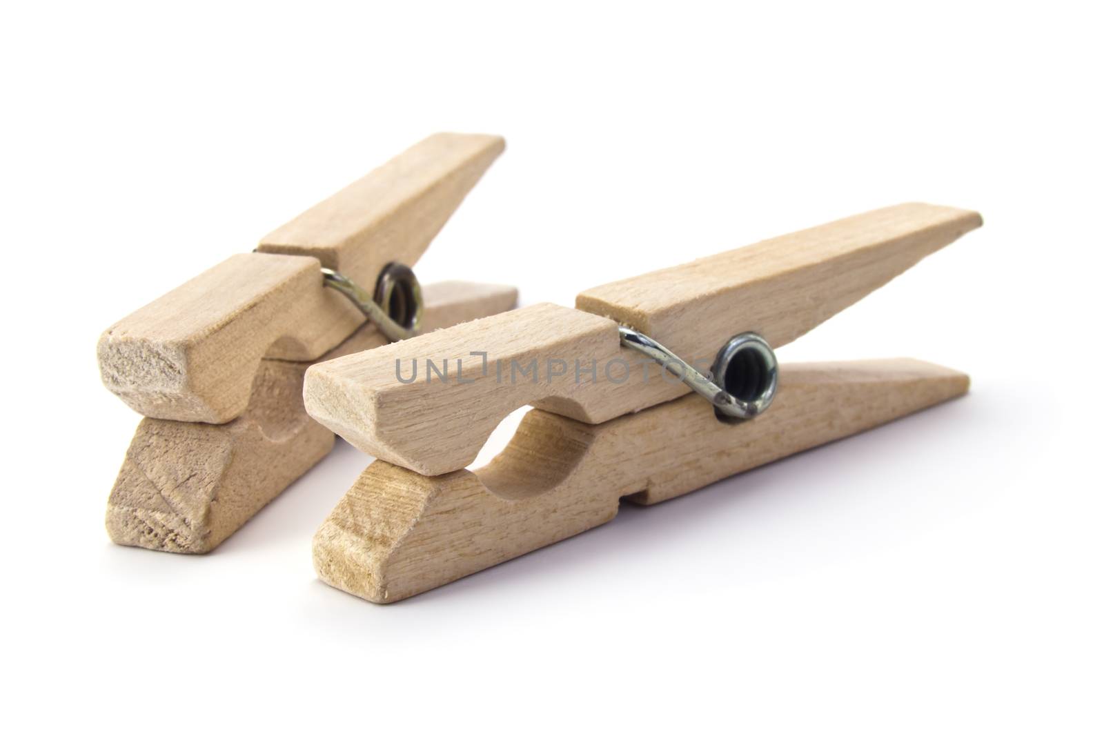 two wooden clothes pegs isolated on white background
