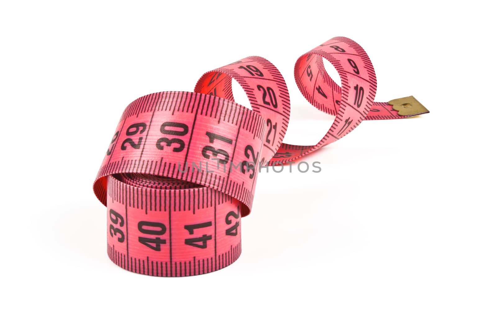 pink tape measure twisted spiral on white background