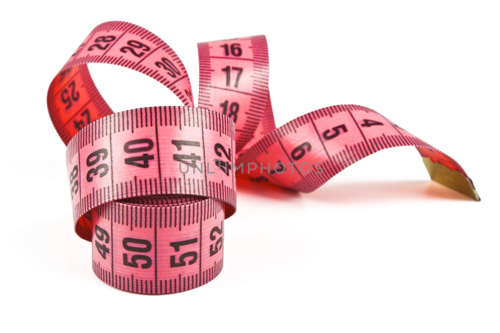 pink tape measure twisted spiral on white background