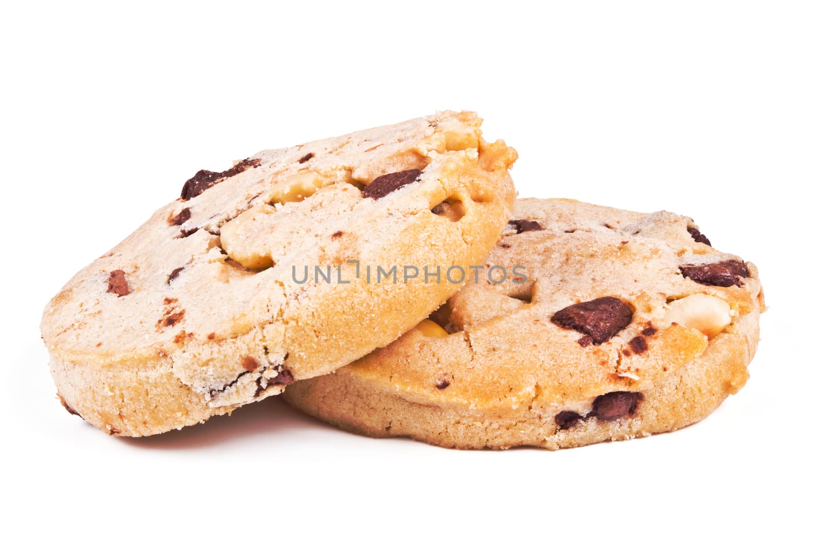 two round biscuits with peanuts and chocolate on white background