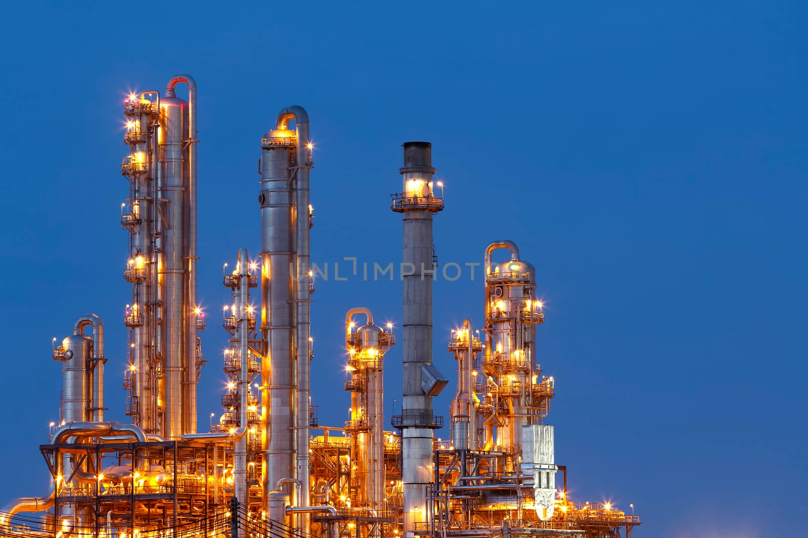 Lighting from structure of oil and chemical factory with blue sky background