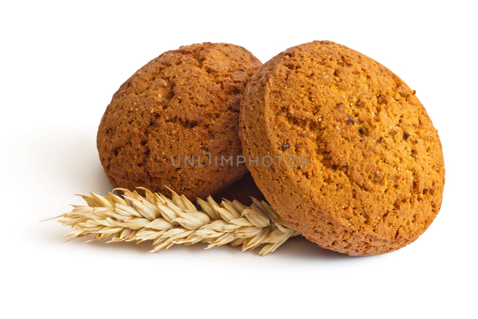 Oatmeal cookies and spikelets on white background