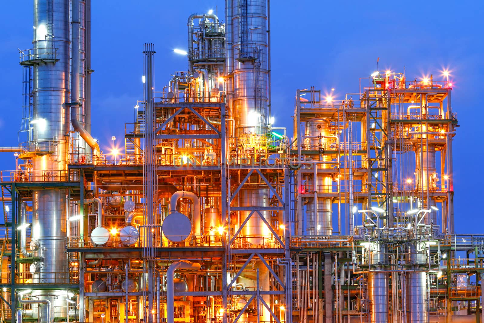 Lighting from structure of oil and chemical factory with blue sky background