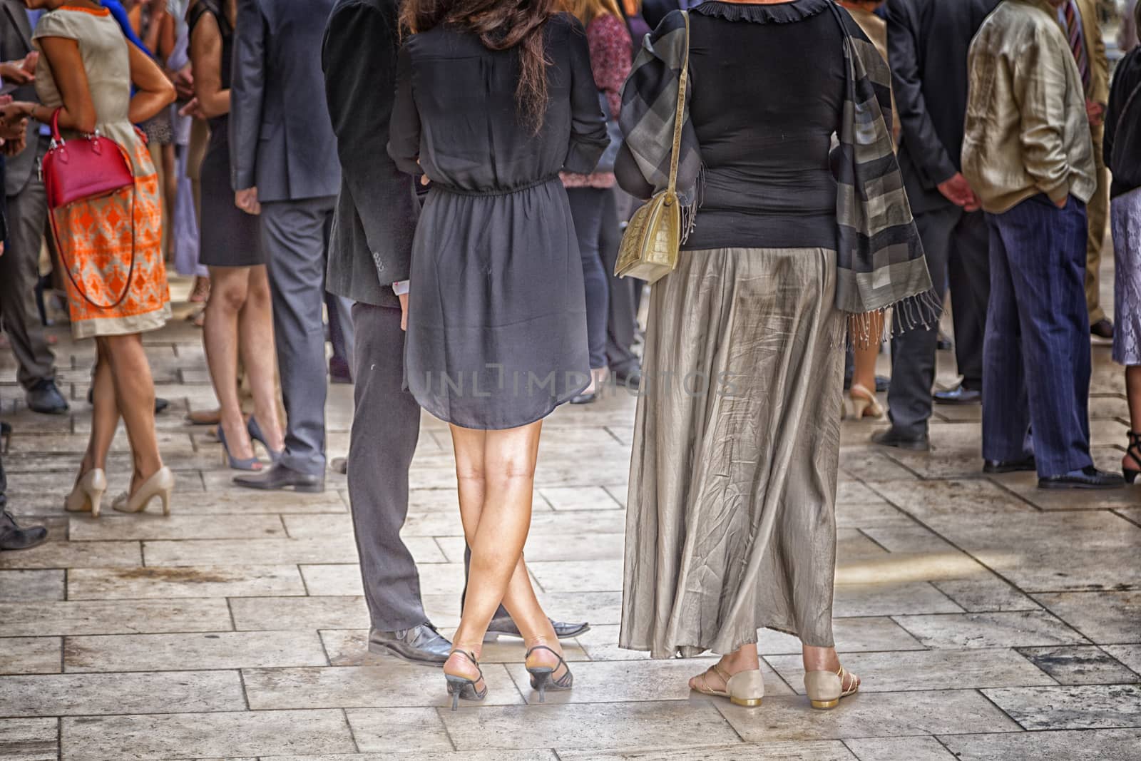 Girl crosses her legs among other smart dressed people