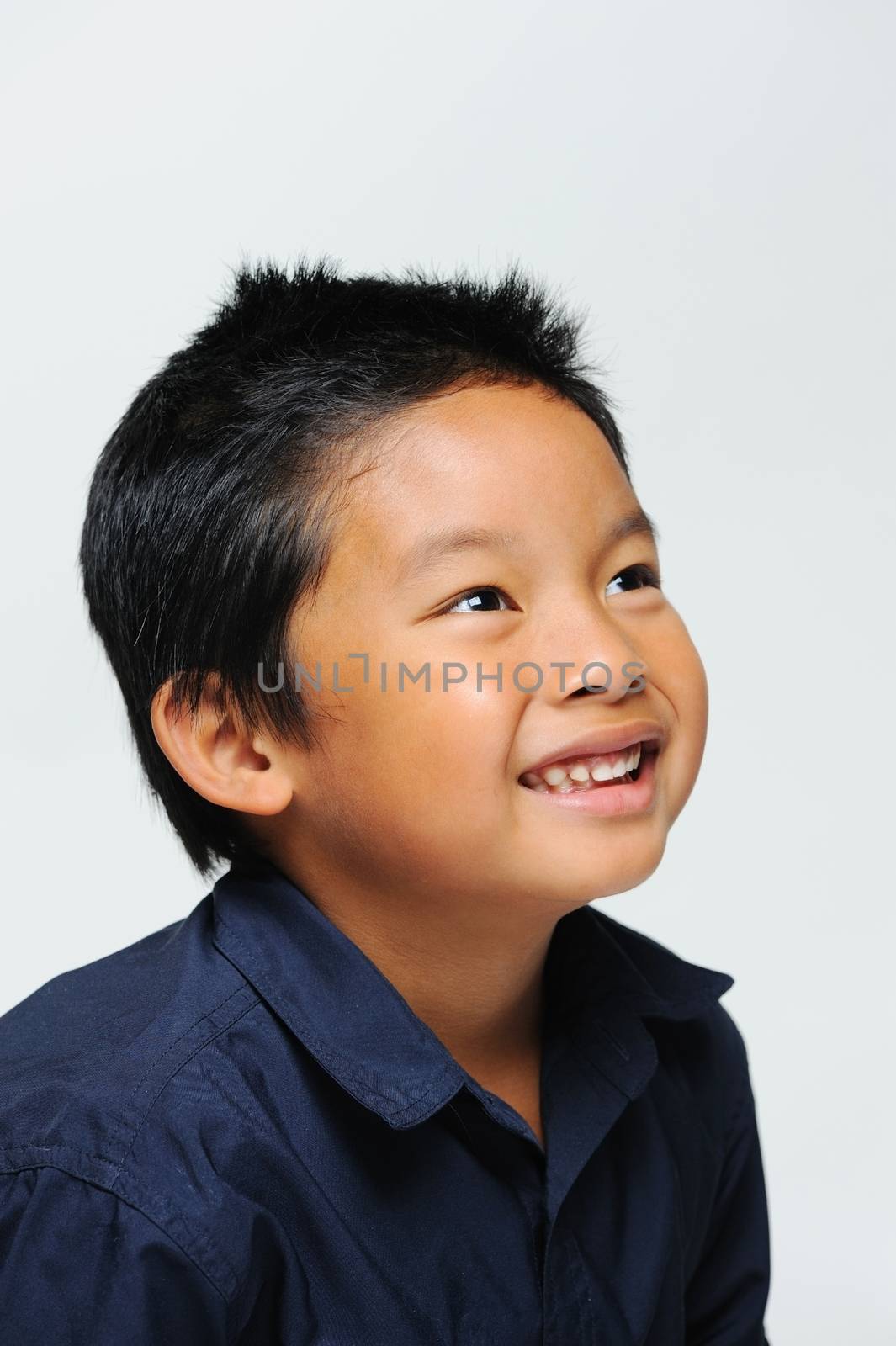 Asian boy looking up and smiling