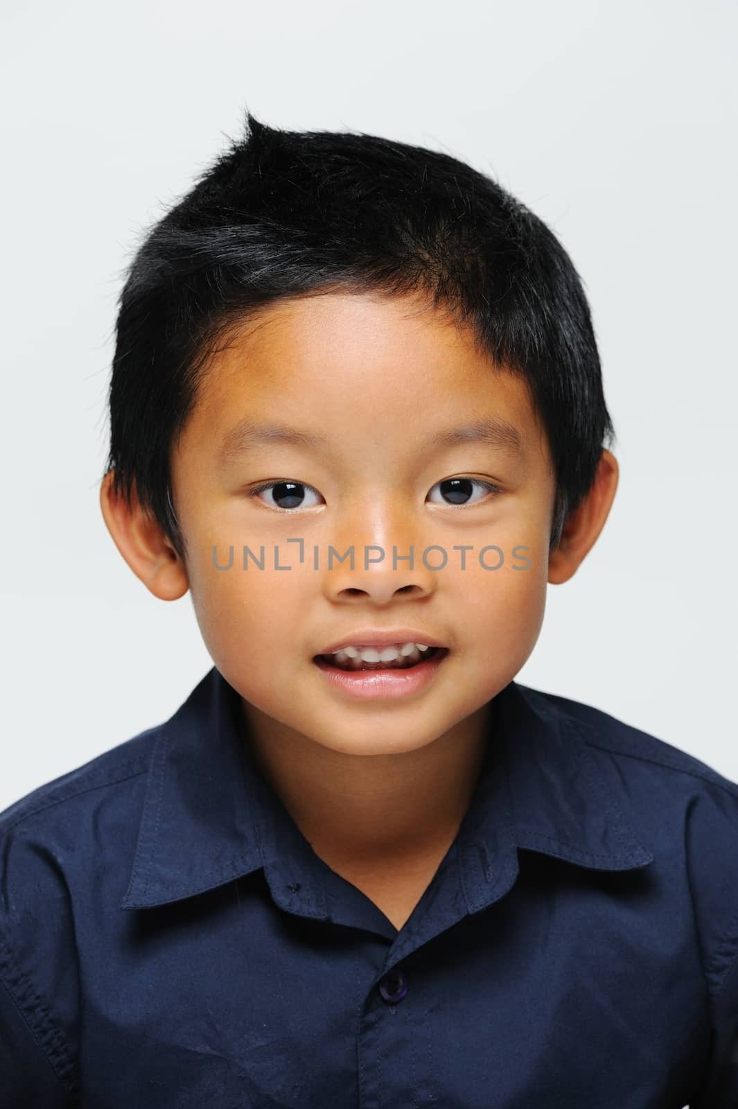 Asian boy looking at camera and smiling