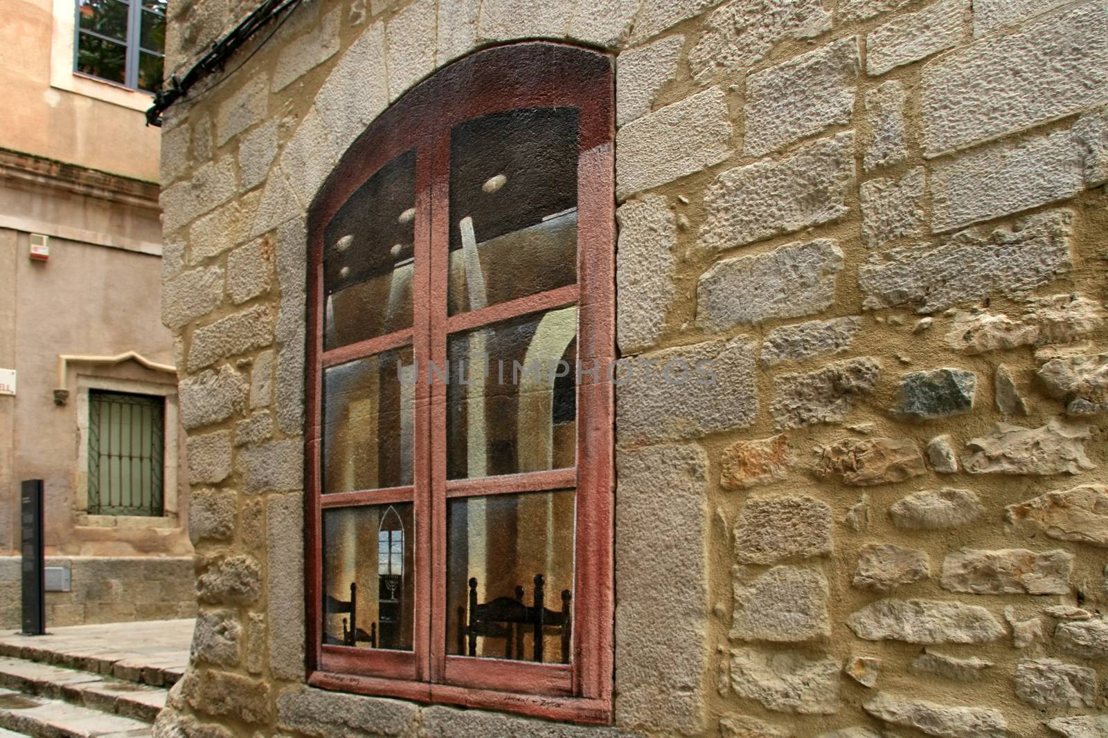 Window painted on old wall. Old city in Kotor