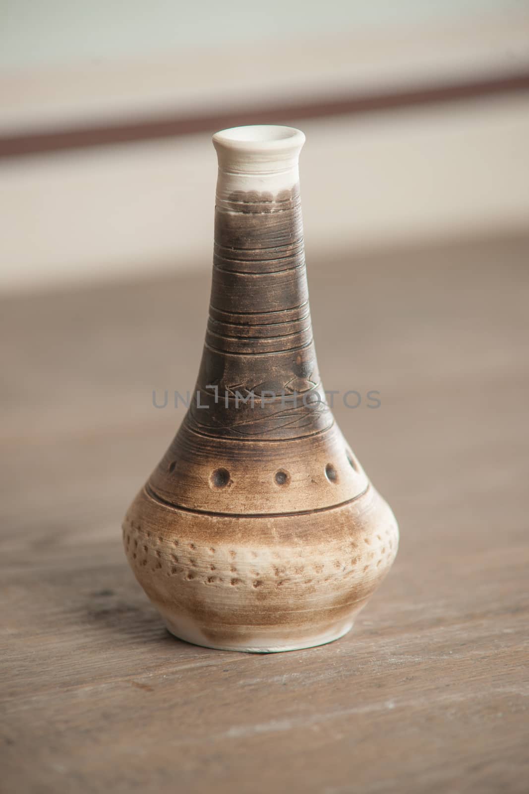 Traditional handcrafted vase of brown color on the table