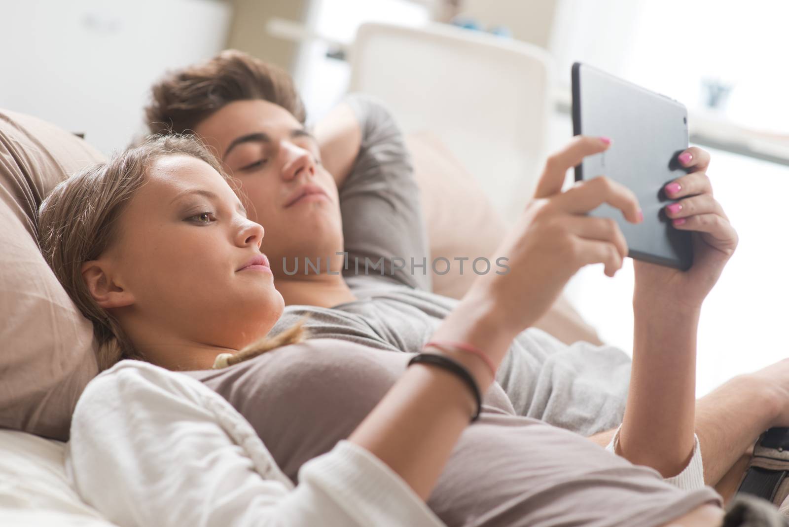 Young couple using digital tablet by stokkete