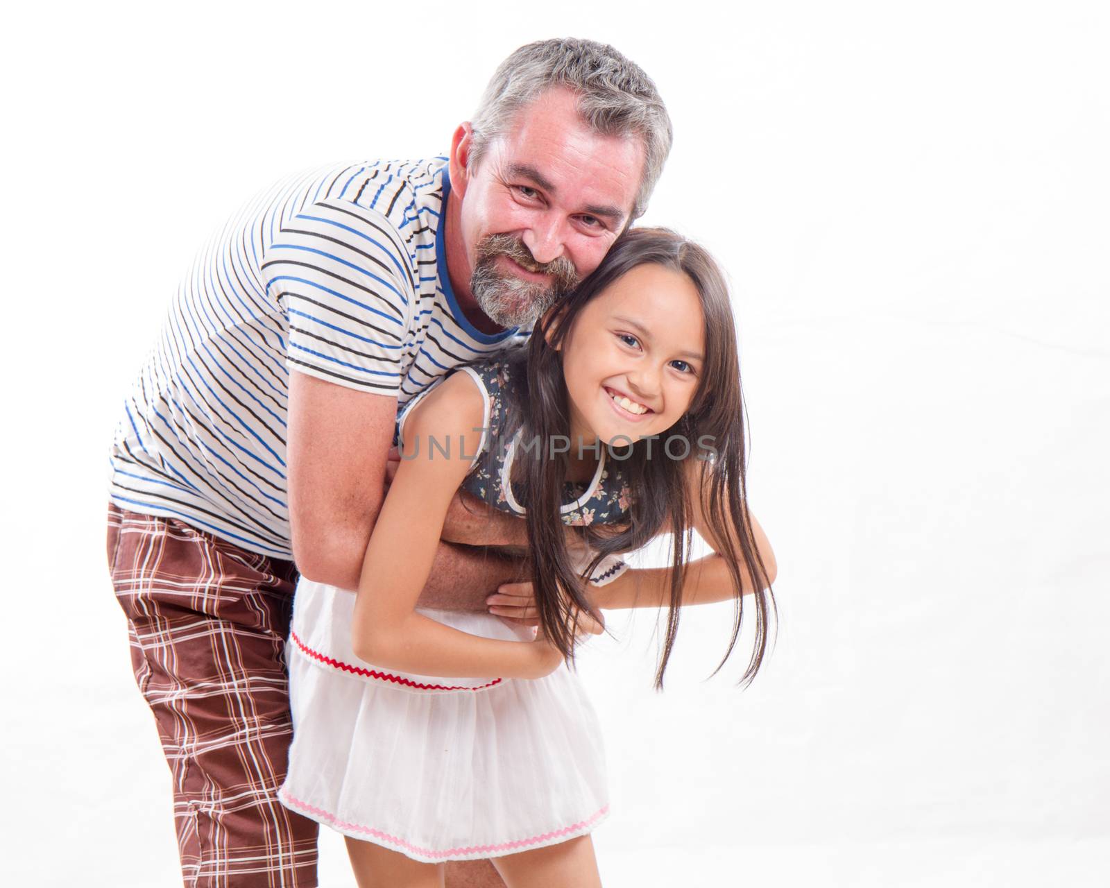 Caucasian father holding mixed race daughter, happy and smiling