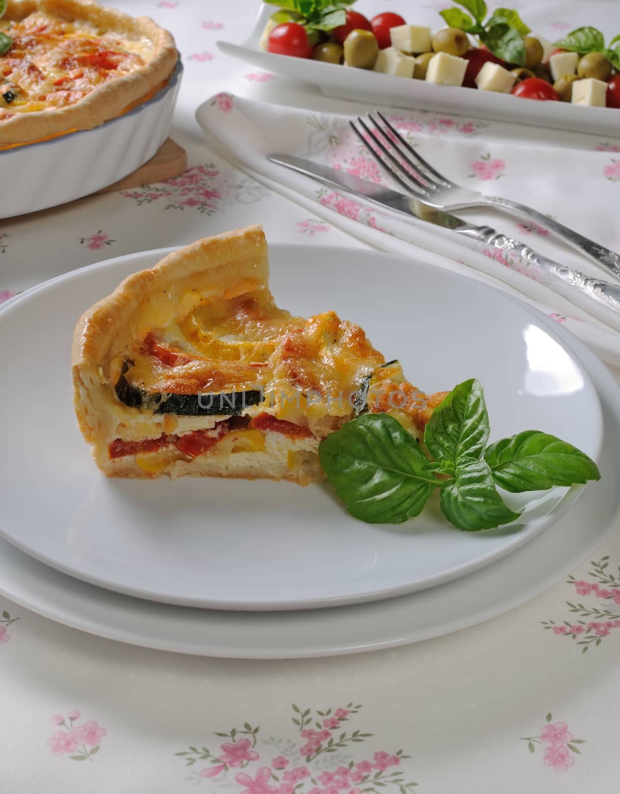 Quiche with zucchini (green, yellow) and tomatoes baked cheese