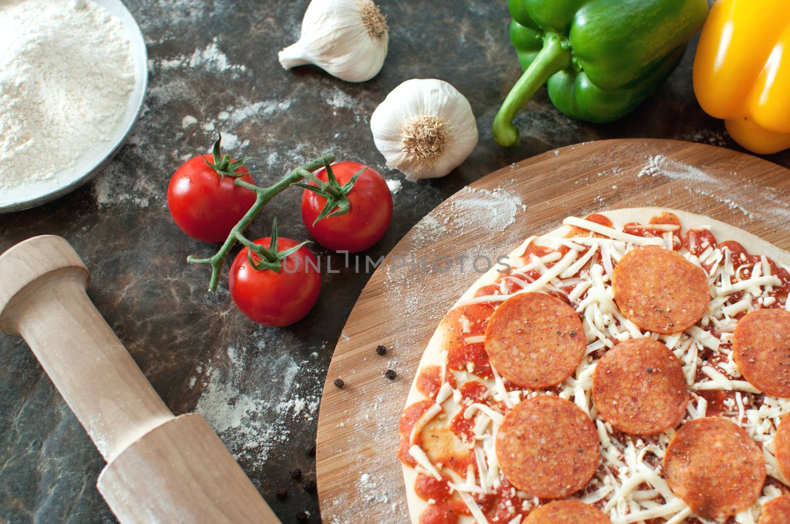 Pepperoni pizza preparation with fresh ingredients 