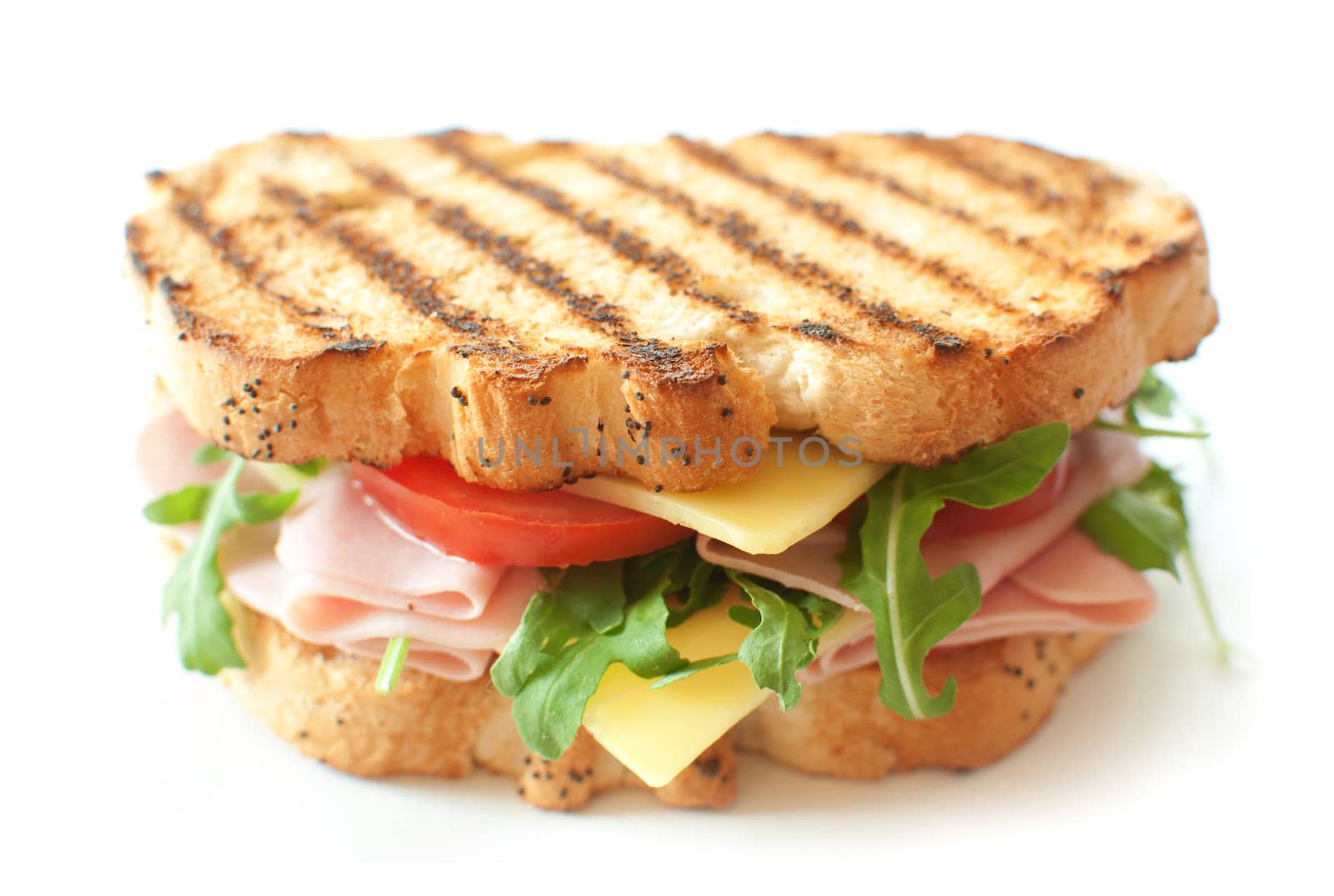 Grilled sandwich with ham and cheese and rocket salad 