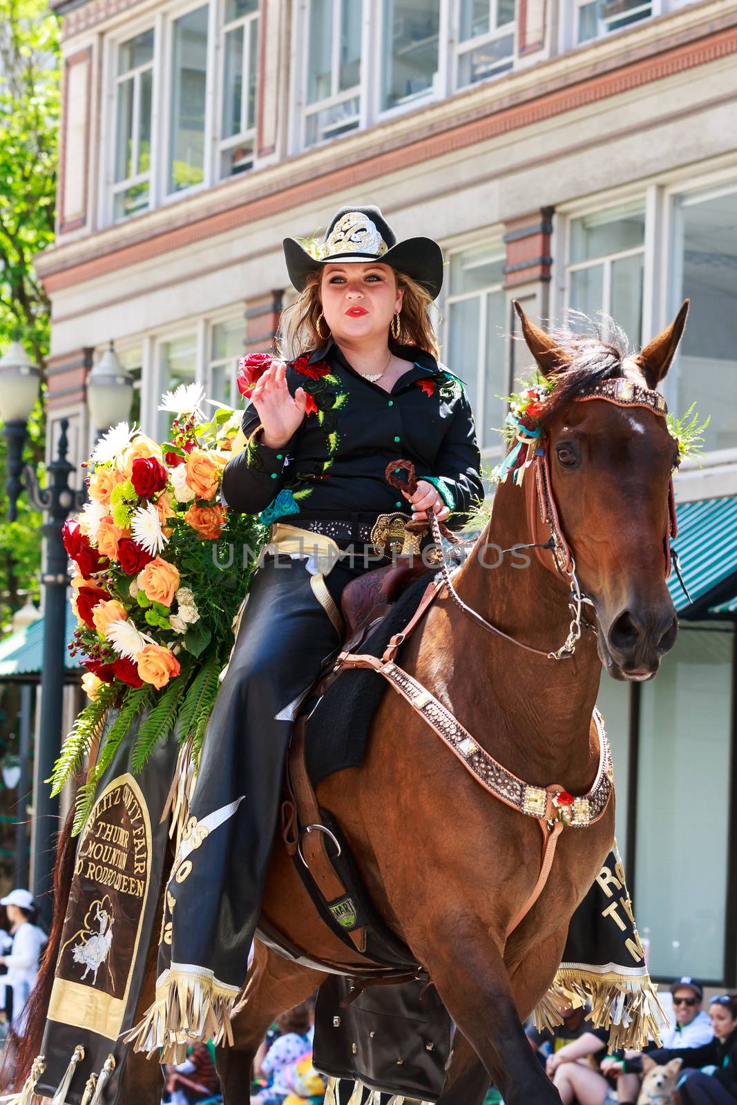 Portland, Oregon, USA - JUNE 7, 2014: Miss Thunder Mountain Pro Rodeo Queen, Brianna Howell in Grand floral parade through Portland downtown.