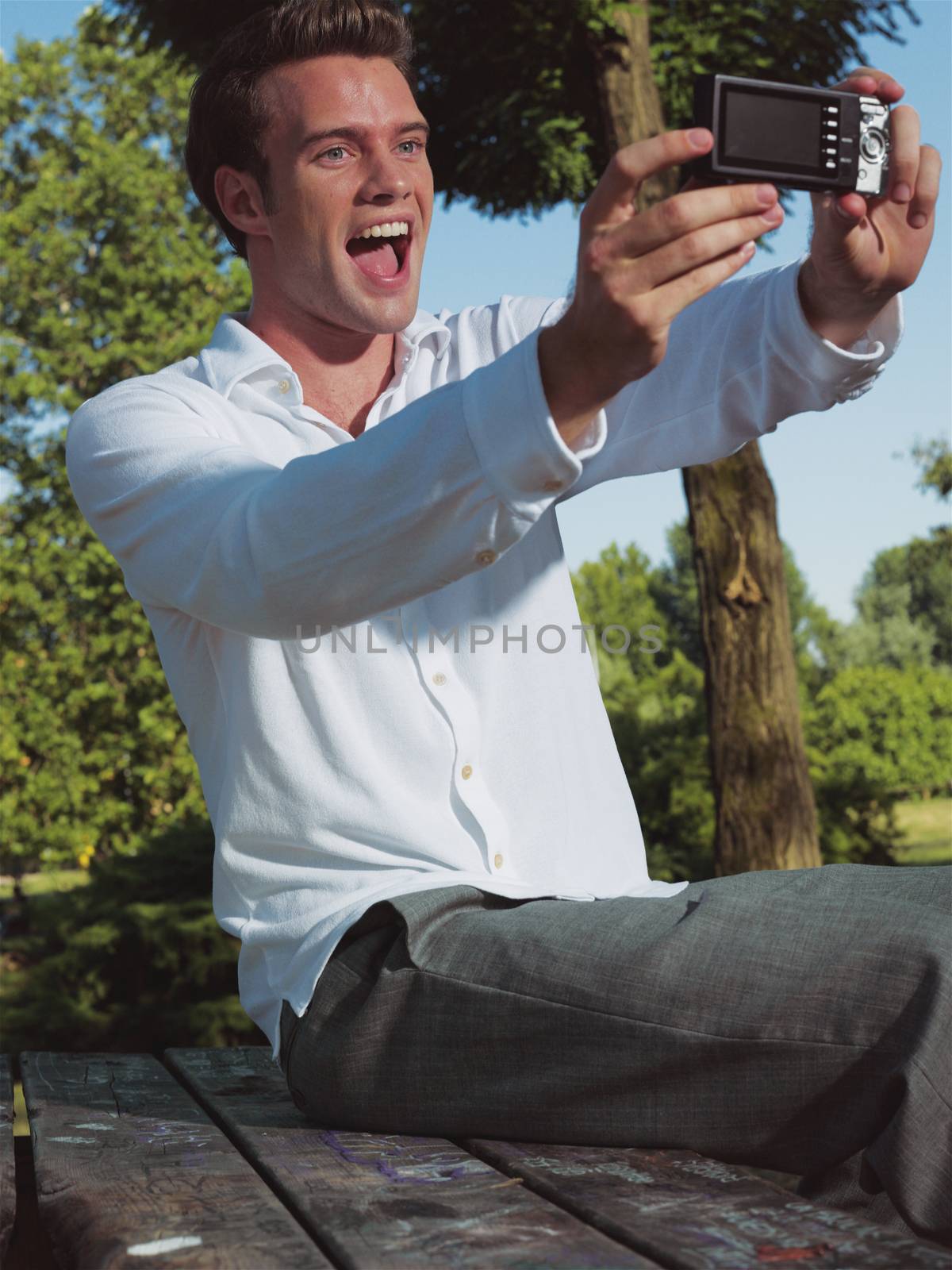 Handsome young guy taking photo