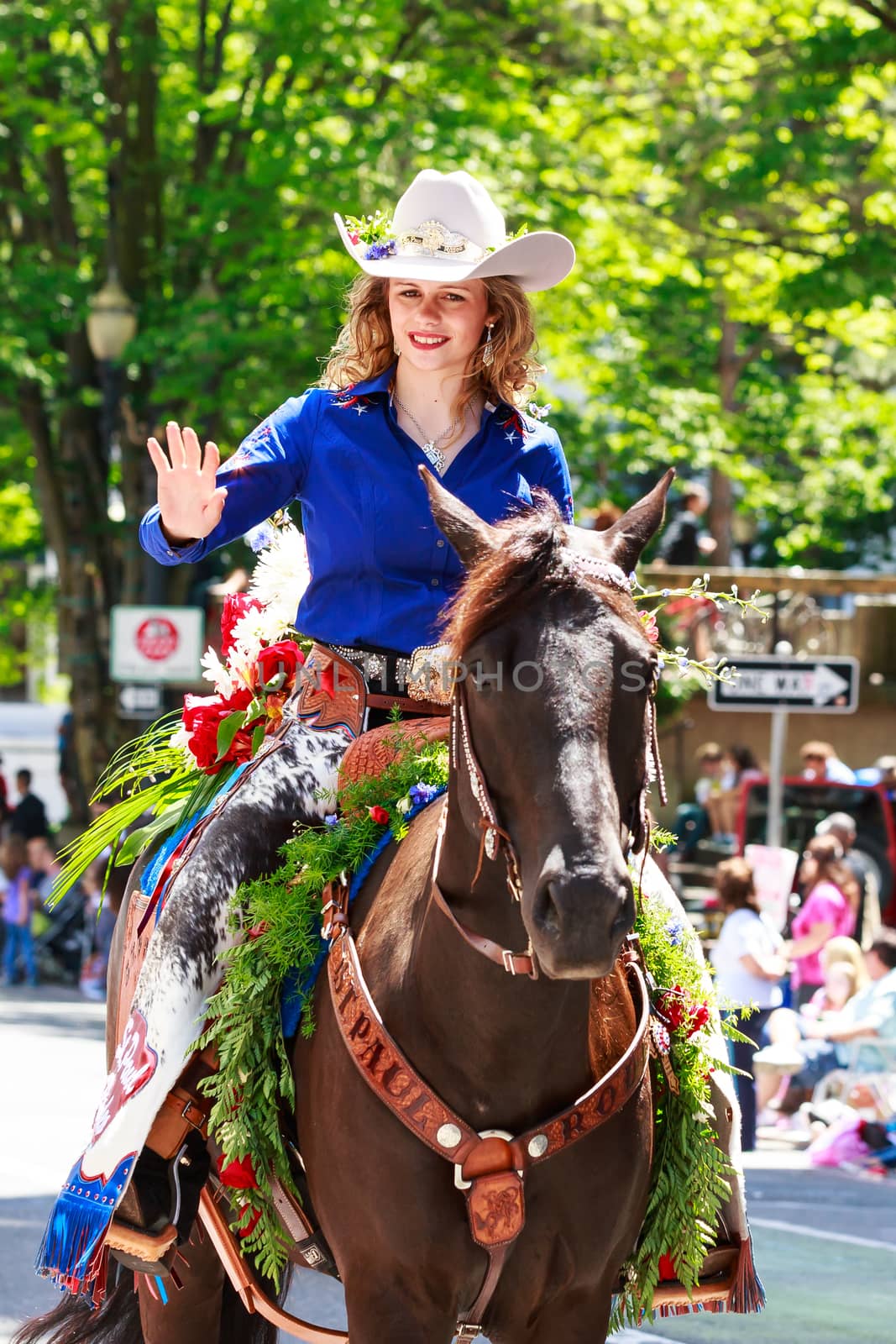 Portland, Oregon, USA - JUNE 7, 2014: St. Paul Rodeo Court in Grand floral parade through Portland downtown.