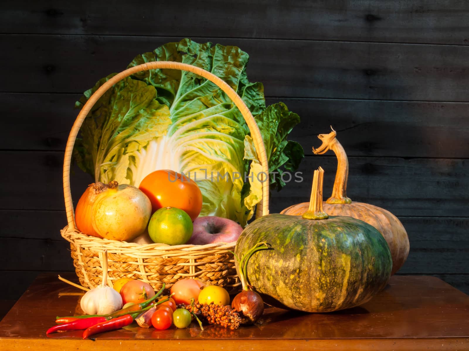 Still life of mix vegetable arranged with basket on old wooden