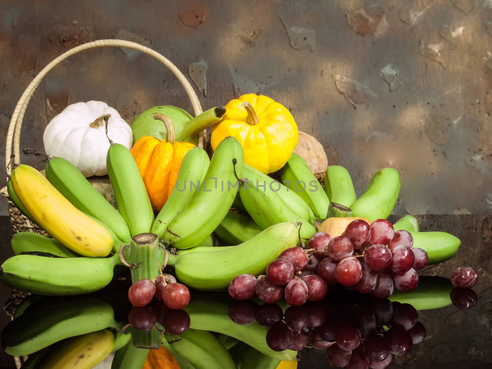 still life lightpaint color-full little pumpkins and banana and grape