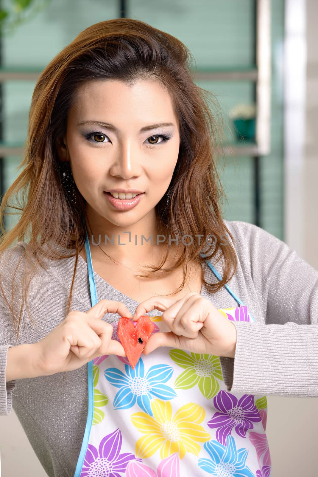 Happy asian woman cooking in the kitchen by Yuri2012