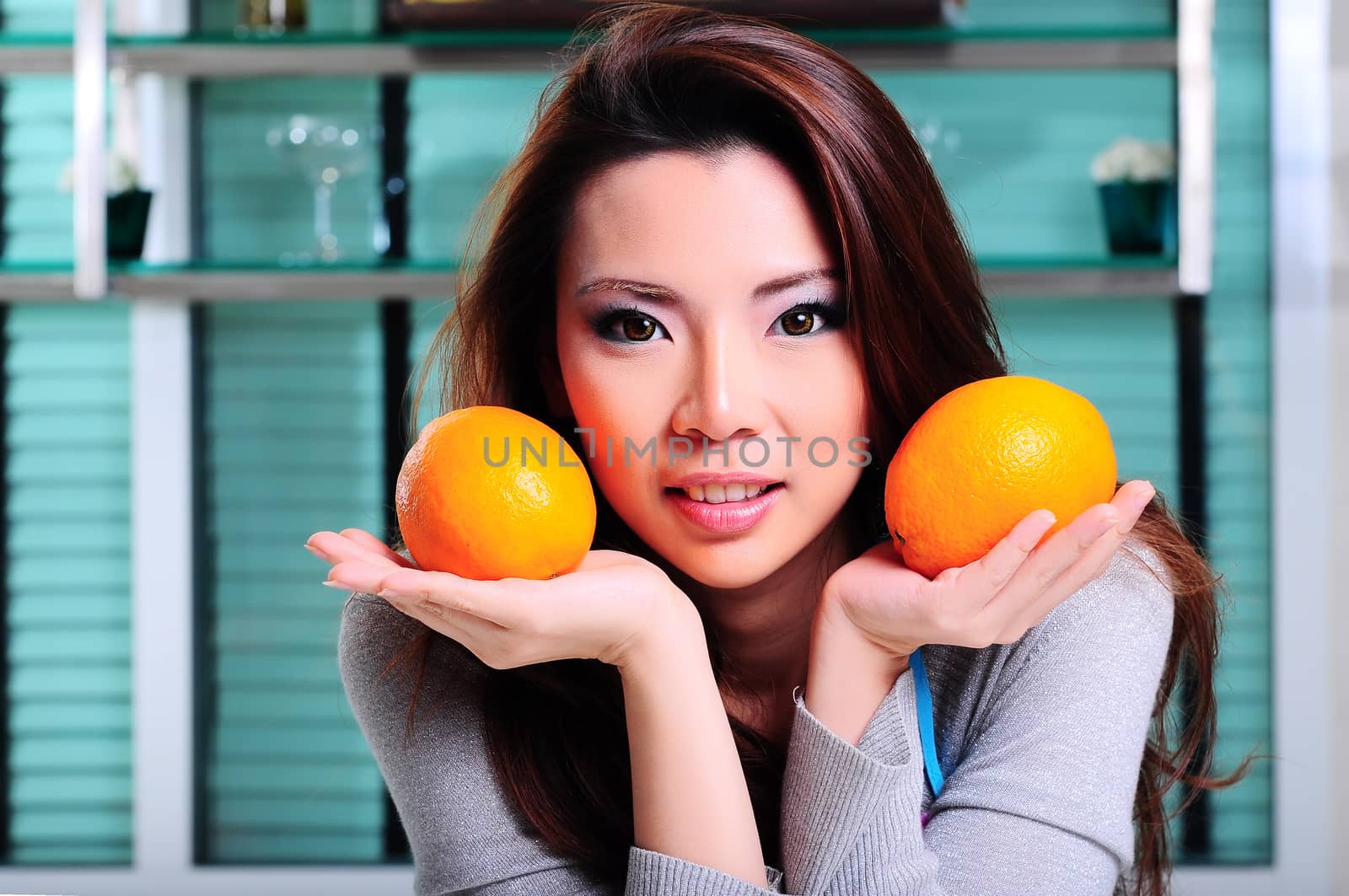 Happy asian woman cooking in the kitchen