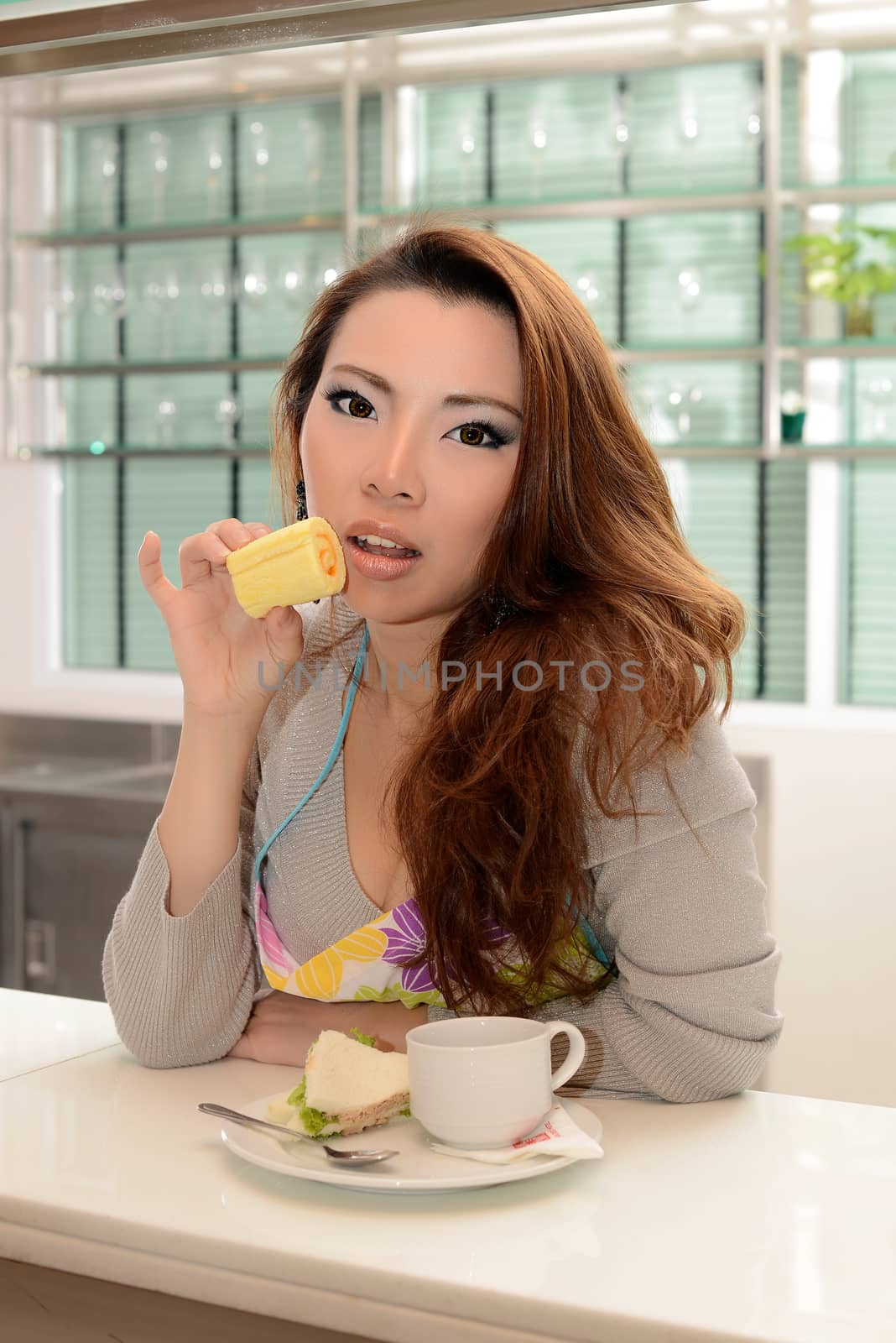 Happy asian woman cooking in the kitchen