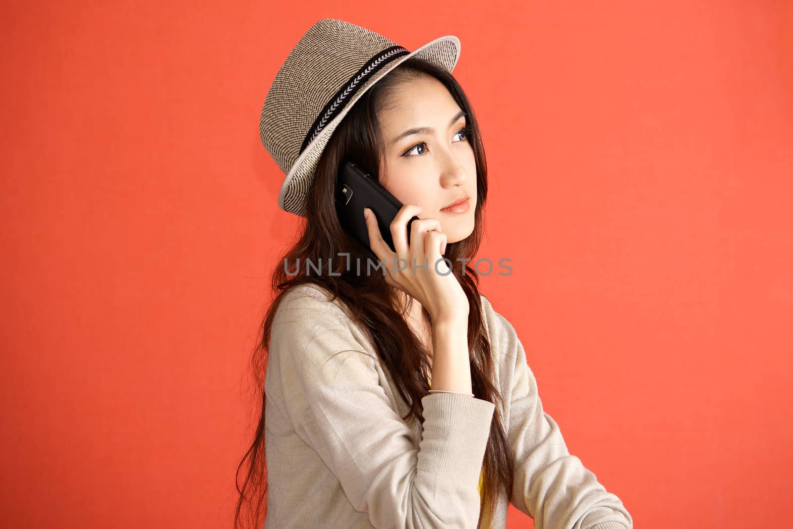 Young Asian woman calling smartphone by Yuri2012